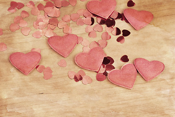 Image showing valentine's fabric and confetti hearts on a wooden retro design background