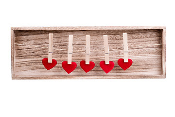 Image showing Red fabric heart hanging on the clothesline