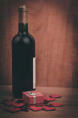 Image showing bottle of vine, red hearts and small present a retro style