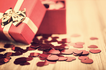 Image showing Red hearts confetti on wooden background in retro color