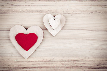 Image showing valentine's wooden hearts on a wooden background