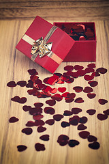 Image showing Red hearts confetti on wooden background in retro color