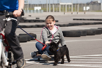 Image showing Skateboarder and cyclist with their dog 