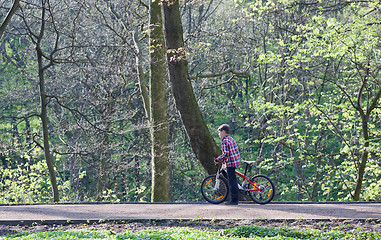 Image showing Young boy with bike in park