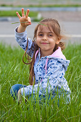 Image showing Little girl with pile in hand