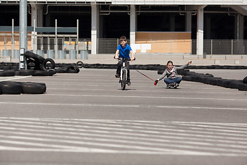 Image showing Cyclist and skateboarder