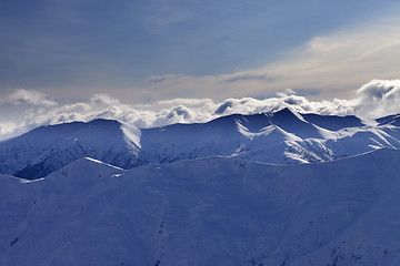 Image showing Winter mountains at evening and sunlight clouds