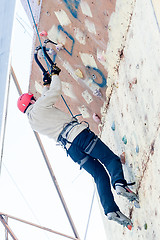 Image showing Man climbs upward on ice climbing competition