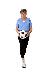Image showing Senior woman walking with football