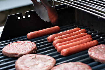 Image showing Hot Dogs and Hamburgers on the Grill