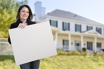 Image showing Hispanic Female Holding Blank Sign In Front of House