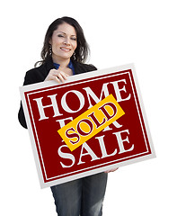 Image showing Hispanic Woman Holding Sold Home For Sale Sign on White