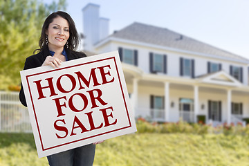 Image showing Woman Holding Home For Sale Sign in Front of House