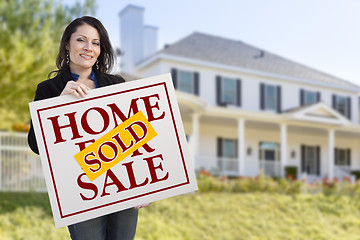 Image showing Woman Holding Sold Home Sale Sign in Front of House