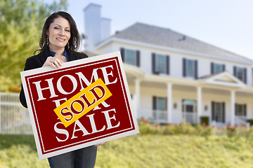 Image showing Woman Holding Sold Home Sale Sign in Front of House