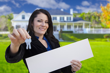 Image showing Woman Holding Blank Sign and Keys In Front of House