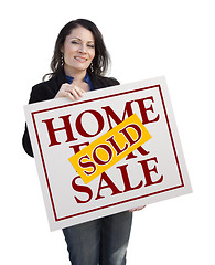 Image showing Hispanic Woman Holding Sold Home For Sale Sign on White