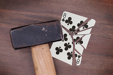 Image showing Hammer with a broken card, eight of clubs