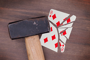 Image showing Hammer with a broken card, eight of diamonds