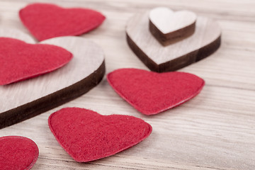 Image showing valentine's fabric and wooden hearts on a wooden background