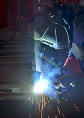 Image showing Welder with protective mask welding 