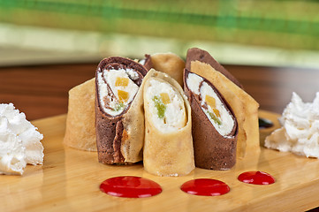 Image showing pancake roll with marmalade