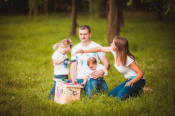 Image showing Happy family with nesting box and paints