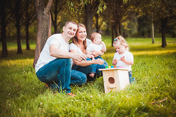 Image showing Happy family with nesting box and paints