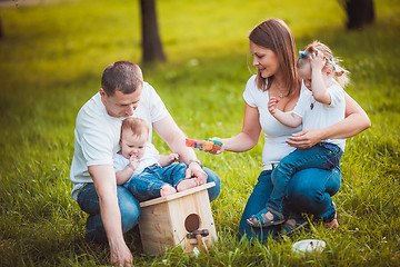 Image showing Happy family with nesting box and paints