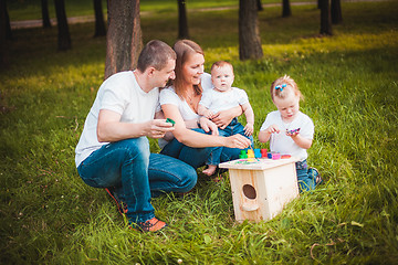 Image showing Happy family with nesting box and paints