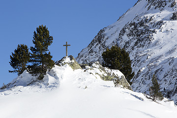 Image showing Cross in snowy mountain landscape