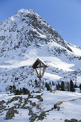 Image showing Cross in snowy mountain landscape