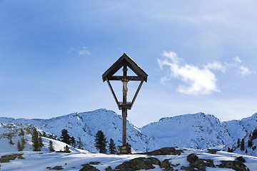 Image showing Cross in snowy mountain landscape