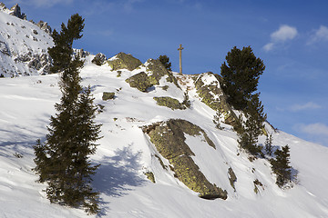 Image showing Cross in snowy mountain landscape