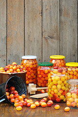 Image showing Preserving Mirabelle plums - jars of homemade fruit preserves - Mirabelle prune