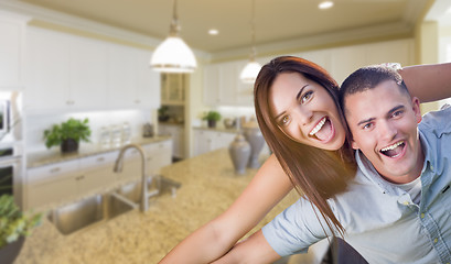 Image showing Playful Young Military Couple Inside Beautiful Custom Kitchen
