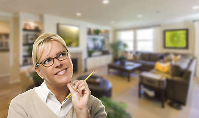 Image showing Daydreaming Woman with Pencil Inside Beautiful Living Room