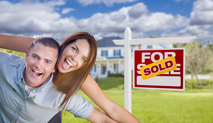 Image showing Military Couple In Front of Home with Sold Sign