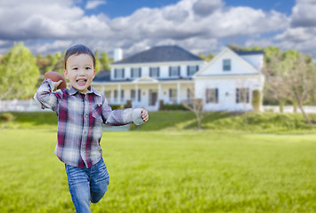 Image showing Cute Mixed Race Boy Playing Ball in His Front Yard