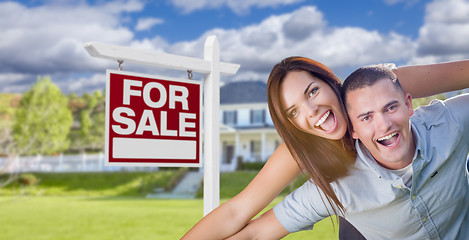 Image showing Military Couple In Front of Home with For Sale Sign