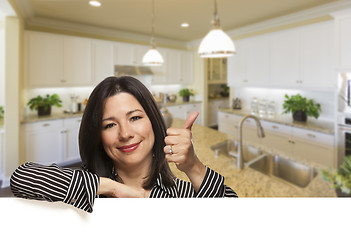 Image showing Hispanic Woman With Thumbs Up in Beautiful Custom Kitchen