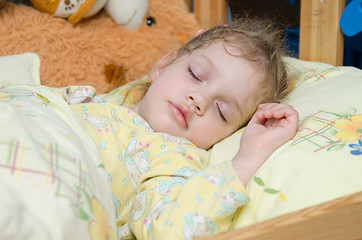 Image showing Three year old girl sleeping in her crib