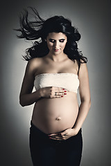 Image showing Pregnant woman over dark background