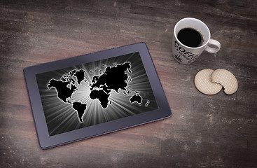 Image showing World map on a tablet