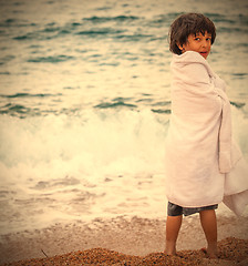 Image showing boy wrapped in a towel on the beach