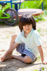 Image showing boy sitting on the sand