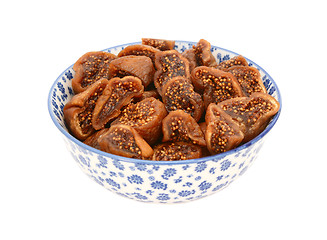 Image showing Chopped dried figs in a blue and white china bowl