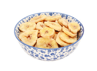 Image showing Dried banana chips in a blue and white china bowl