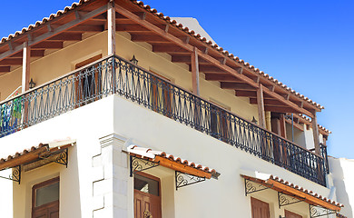 Image showing Detail of the facade of an old house with balconies and a sun aw