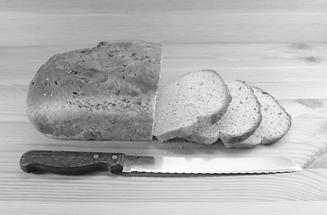 Image showing Three slices cut from a loaf of bread with a knife